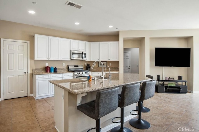 kitchen featuring white cabinetry, sink, a kitchen island with sink, and stainless steel appliances