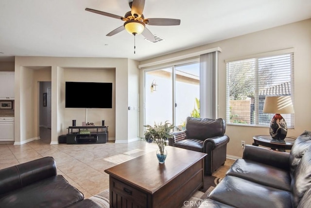 living room with ceiling fan and light tile patterned flooring