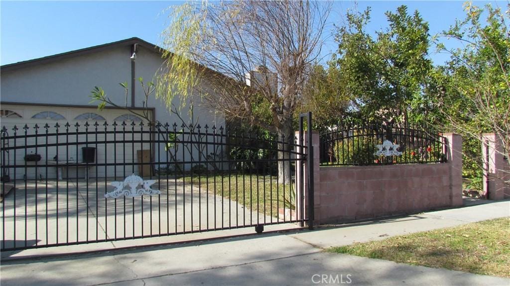 view of gate with a garage