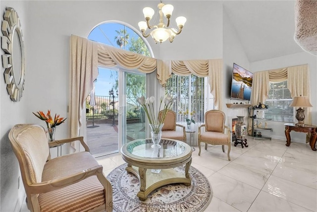 sitting room featuring high vaulted ceiling and an inviting chandelier