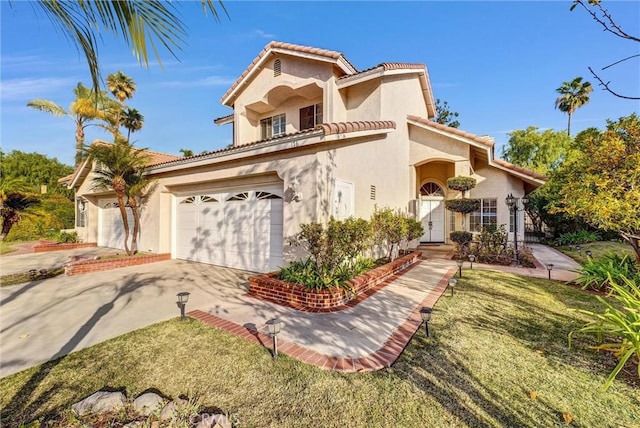 mediterranean / spanish-style home featuring a garage and a front yard