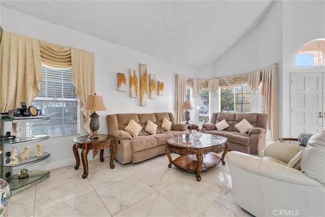 living room with high vaulted ceiling