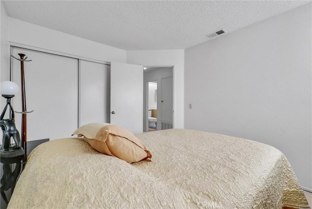 bedroom with a closet and a textured ceiling