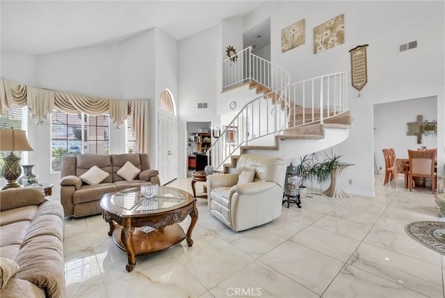 living room featuring a towering ceiling