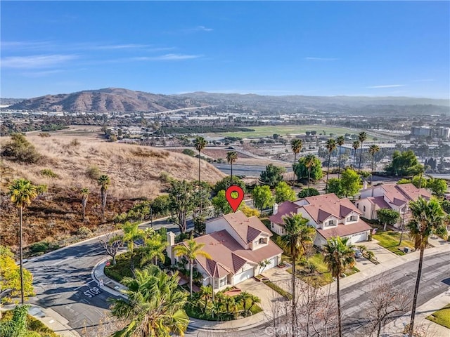 birds eye view of property with a mountain view