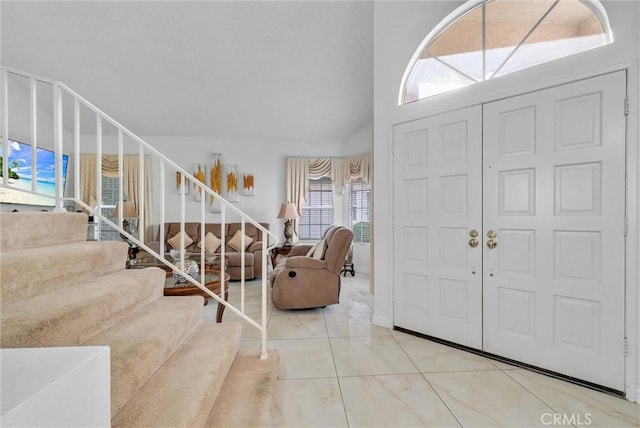 foyer featuring a towering ceiling and tile patterned floors