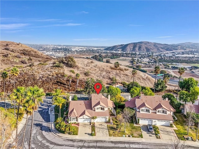 birds eye view of property with a mountain view