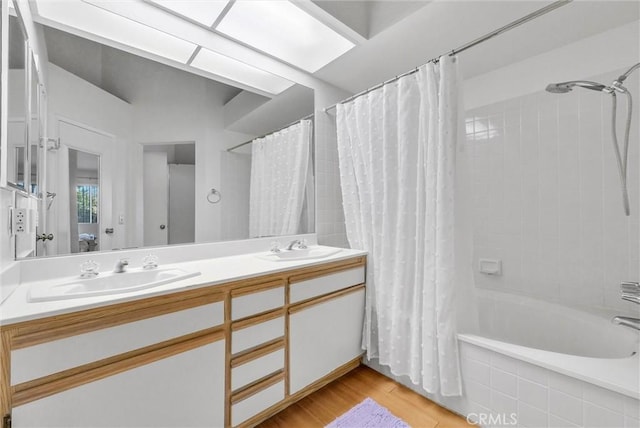 bathroom featuring vanity, shower / tub combo, and hardwood / wood-style floors