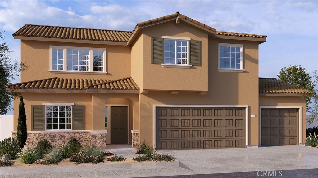 mediterranean / spanish home featuring a garage