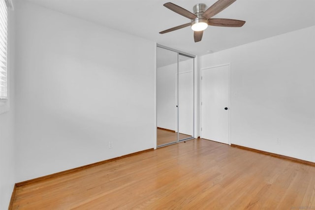 spare room with ceiling fan and wood-type flooring