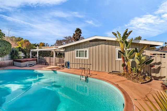 view of pool with a hot tub and a patio