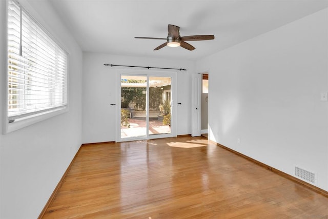 unfurnished room with ceiling fan and light wood-type flooring