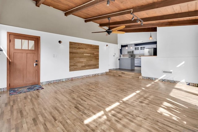 unfurnished living room with beamed ceiling, ceiling fan, hardwood / wood-style floors, and wood ceiling