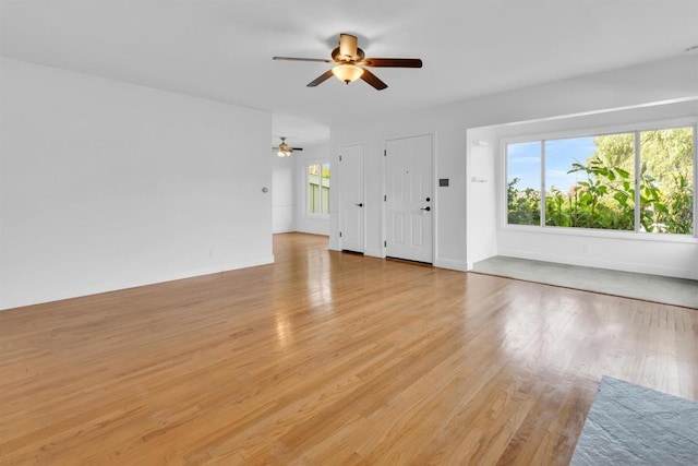 unfurnished living room with ceiling fan and light wood-type flooring