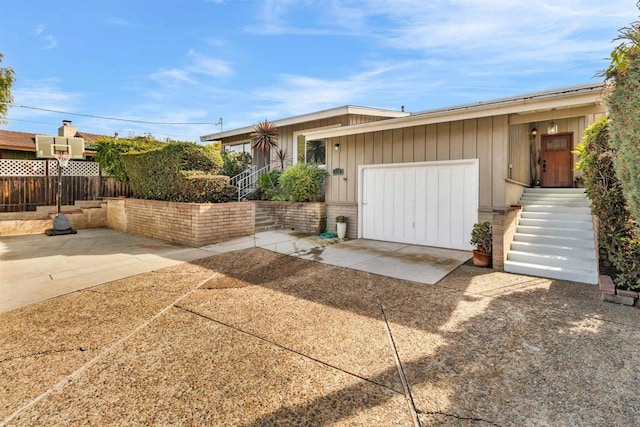 view of front of home with a garage and a patio area