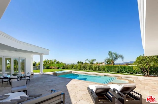 view of pool with a patio, an outdoor hangout area, and an in ground hot tub