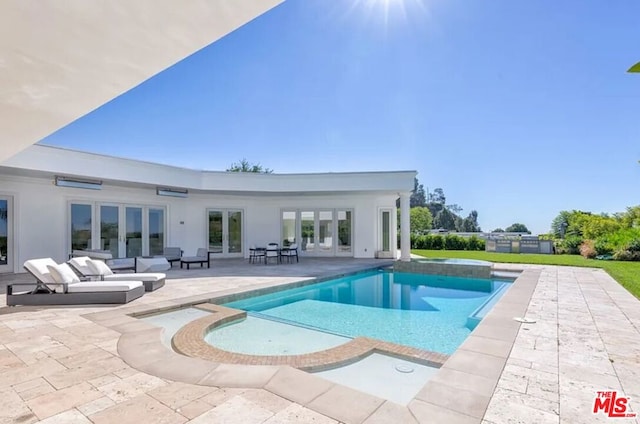 view of swimming pool featuring a patio and french doors