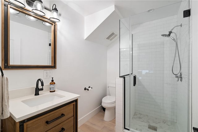 bathroom featuring vanity, toilet, an enclosed shower, and hardwood / wood-style floors