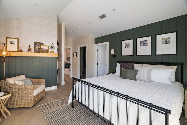 bedroom featuring hardwood / wood-style flooring and lofted ceiling