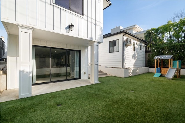 back of property featuring a yard, a playground, and a patio