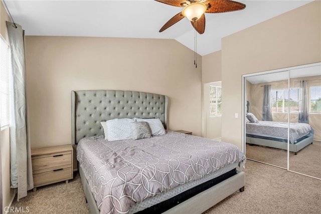 carpeted bedroom with lofted ceiling, a closet, and ceiling fan