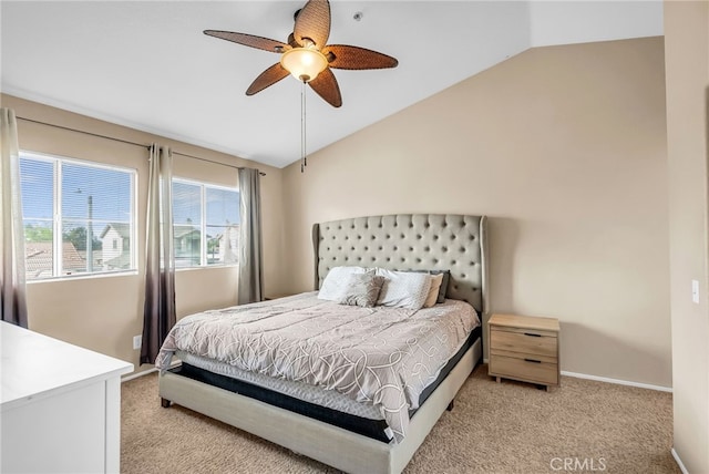 bedroom with ceiling fan, vaulted ceiling, and light carpet