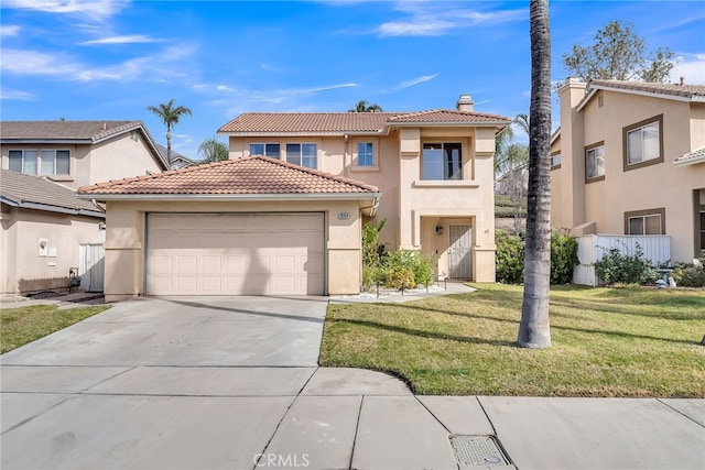 mediterranean / spanish house with a garage and a front lawn