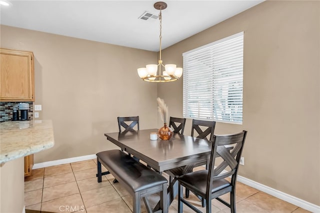 dining area featuring a notable chandelier and light tile patterned floors