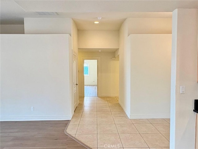 hall featuring light tile patterned floors