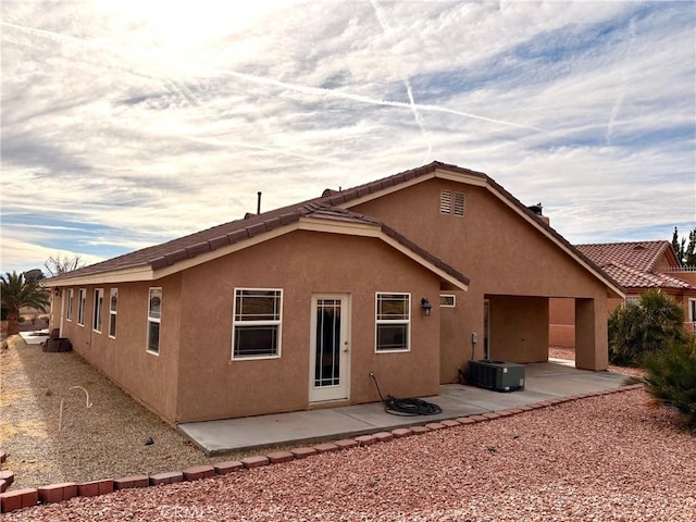 rear view of property featuring central AC unit and a patio