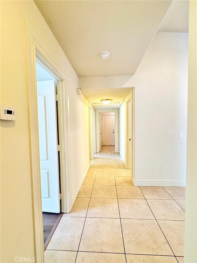 hall with light tile patterned floors