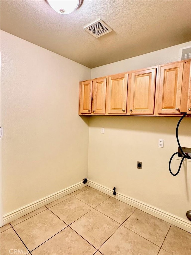 laundry room with light tile patterned floors, cabinets, washer hookup, hookup for a gas dryer, and hookup for an electric dryer