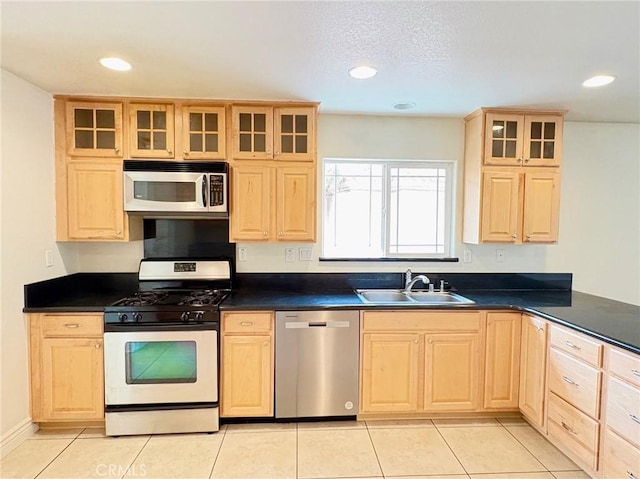 kitchen featuring light tile patterned floors, appliances with stainless steel finishes, sink, and light brown cabinets