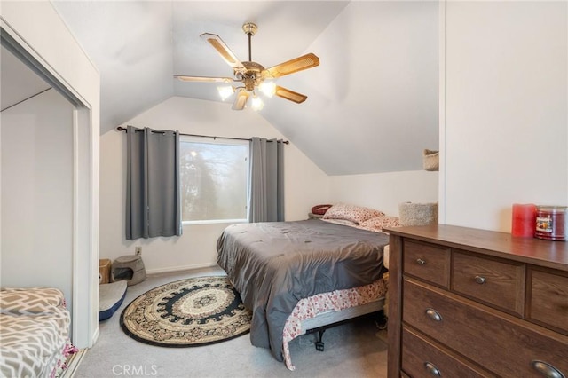 carpeted bedroom with ceiling fan and lofted ceiling