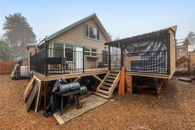 back of property with a wooden deck