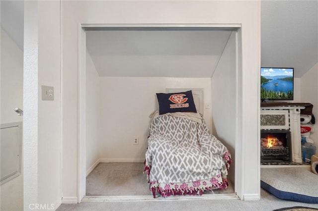 carpeted bedroom with lofted ceiling