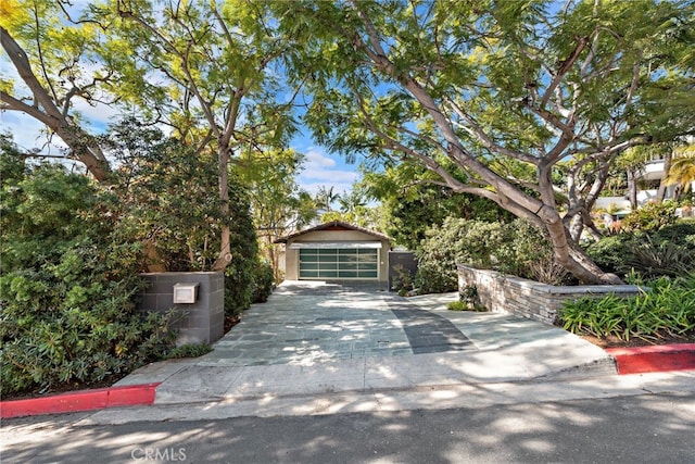 view of front of house featuring a garage and an outdoor structure