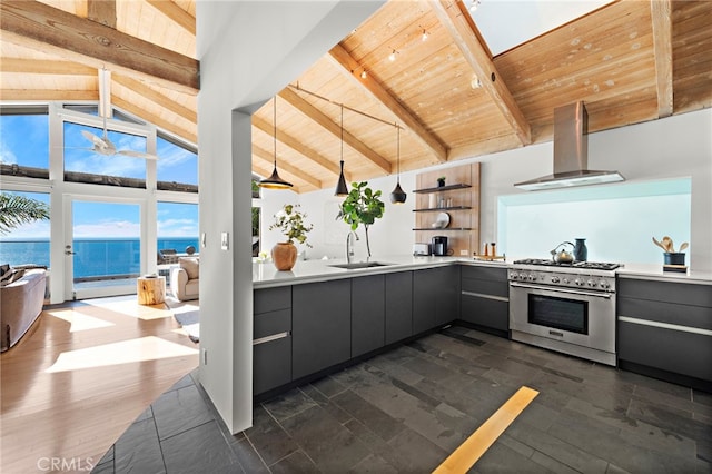 kitchen featuring a water view, decorative light fixtures, wooden ceiling, stainless steel range, and wall chimney range hood