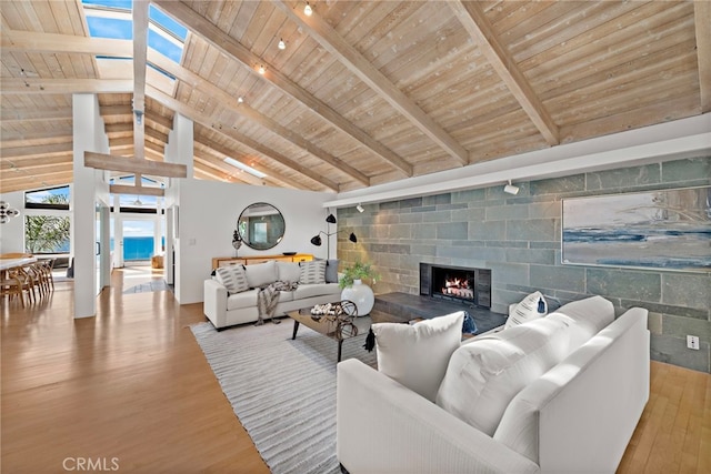 living room featuring beamed ceiling, high vaulted ceiling, hardwood / wood-style floors, and wood ceiling