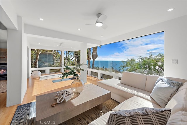 living room with hardwood / wood-style floors and ceiling fan