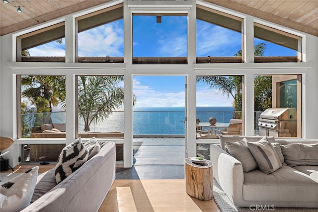 living room featuring a water view, high vaulted ceiling, wood ceiling, and light hardwood / wood-style floors