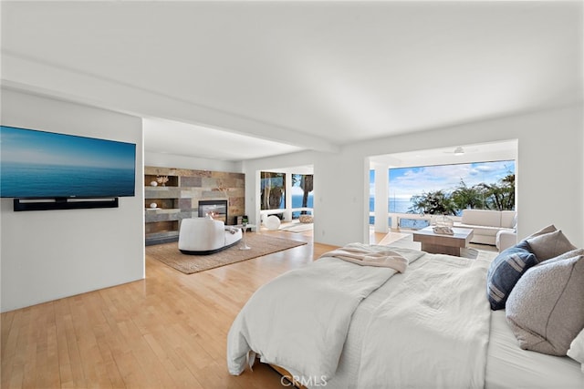 bedroom featuring hardwood / wood-style flooring and beamed ceiling