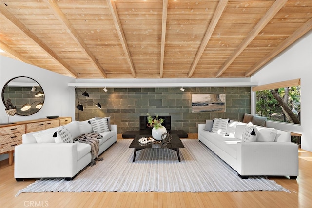 unfurnished living room featuring lofted ceiling with beams, wooden ceiling, and light hardwood / wood-style floors