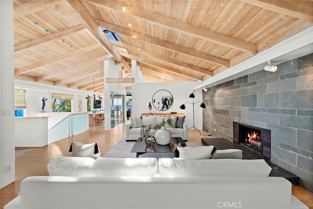 living room featuring wood ceiling, lofted ceiling with skylight, and light wood-type flooring