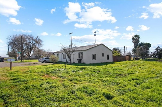 view of side of home featuring a lawn