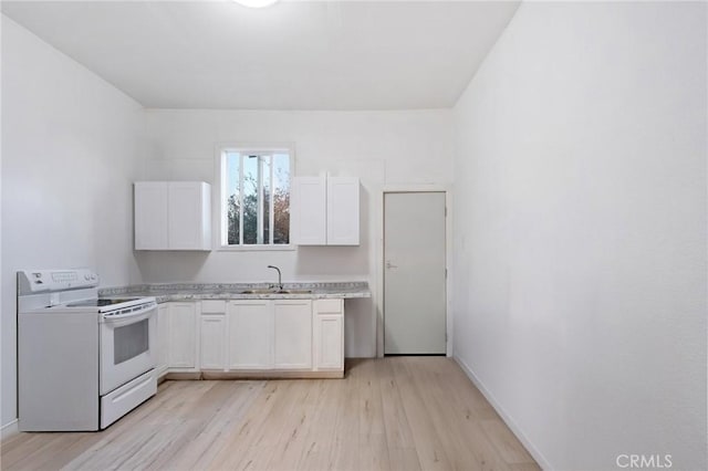 kitchen with white range with electric stovetop, light countertops, white cabinets, a sink, and light wood-type flooring