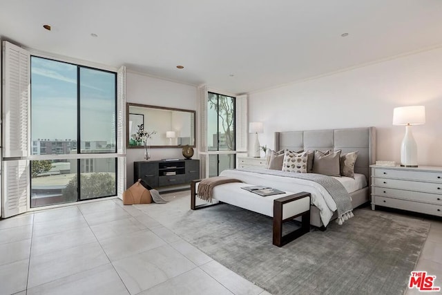 tiled bedroom featuring a wall of windows and ornamental molding