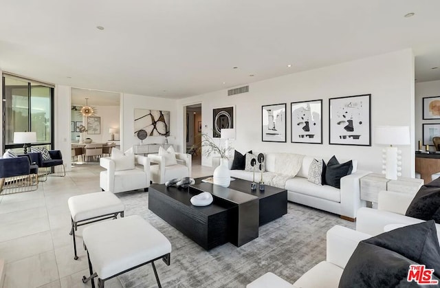 tiled living room with a wall of windows