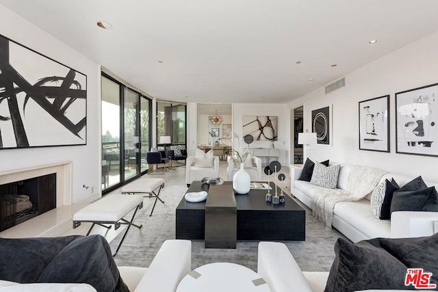 living room featuring expansive windows and a premium fireplace