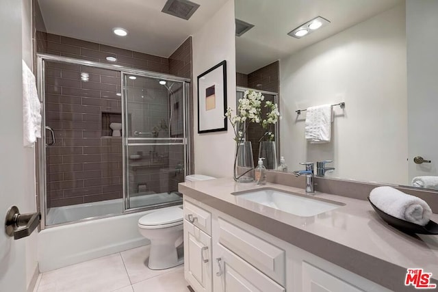 full bathroom featuring vanity, tile patterned floors, shower / bath combination with glass door, and toilet